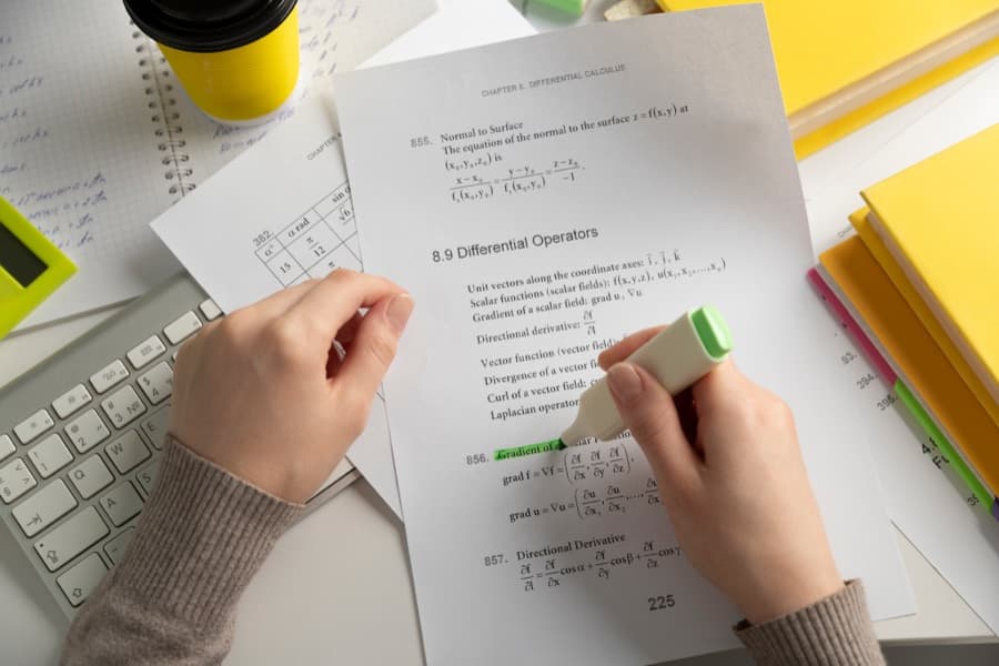 Hands marking a printed test paper
