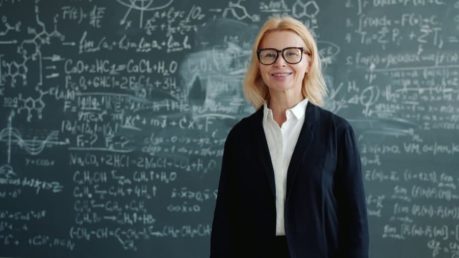 A class teacher in front of her blackboard